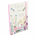 Wild Harmony A5 notebook with a cream wildflower and dragonfly cover, ‘Notes’ lettering and a pink elastic closure, on a white background.