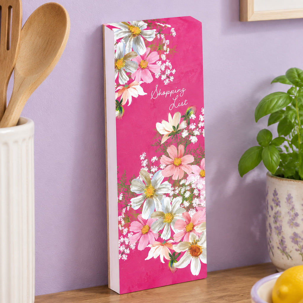 Floral-themed shopping list on a pink background