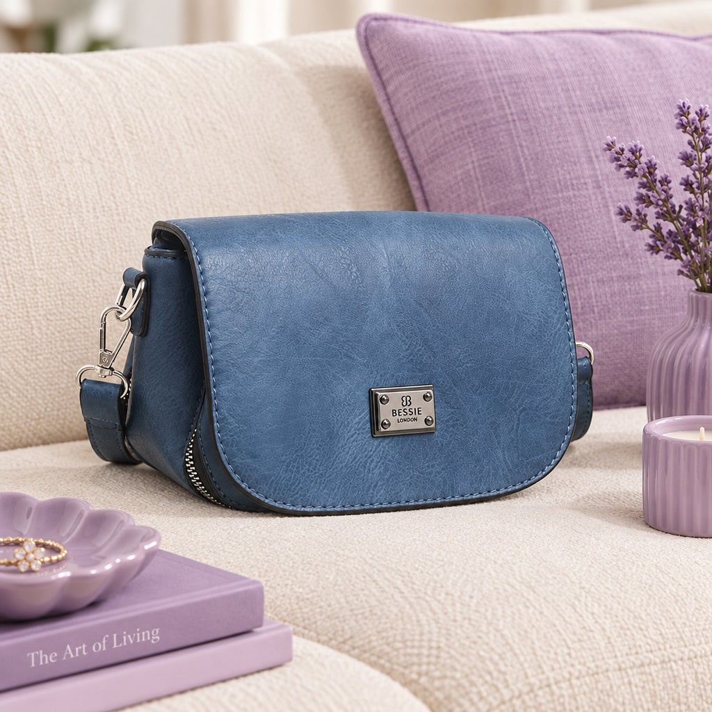 Blue handbag with a silver zipper on a white background