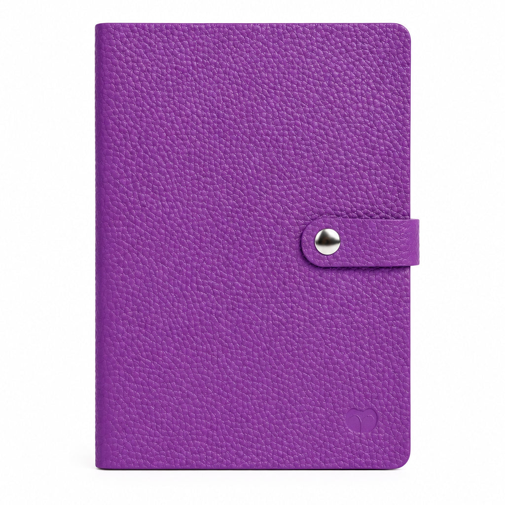 Purple A5 notebook with a textured cover and matching strap with a silver-tone snap-button closure, on a white background.