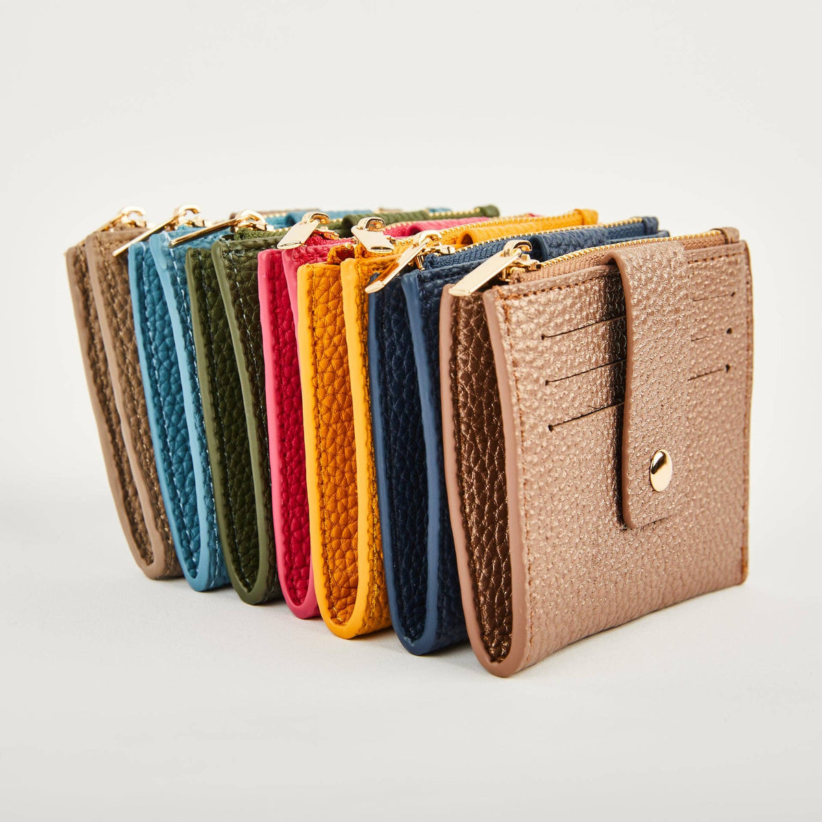 Pearl Duo purses arranged in a row in assorted colours, showing card slots and gold-tone zips