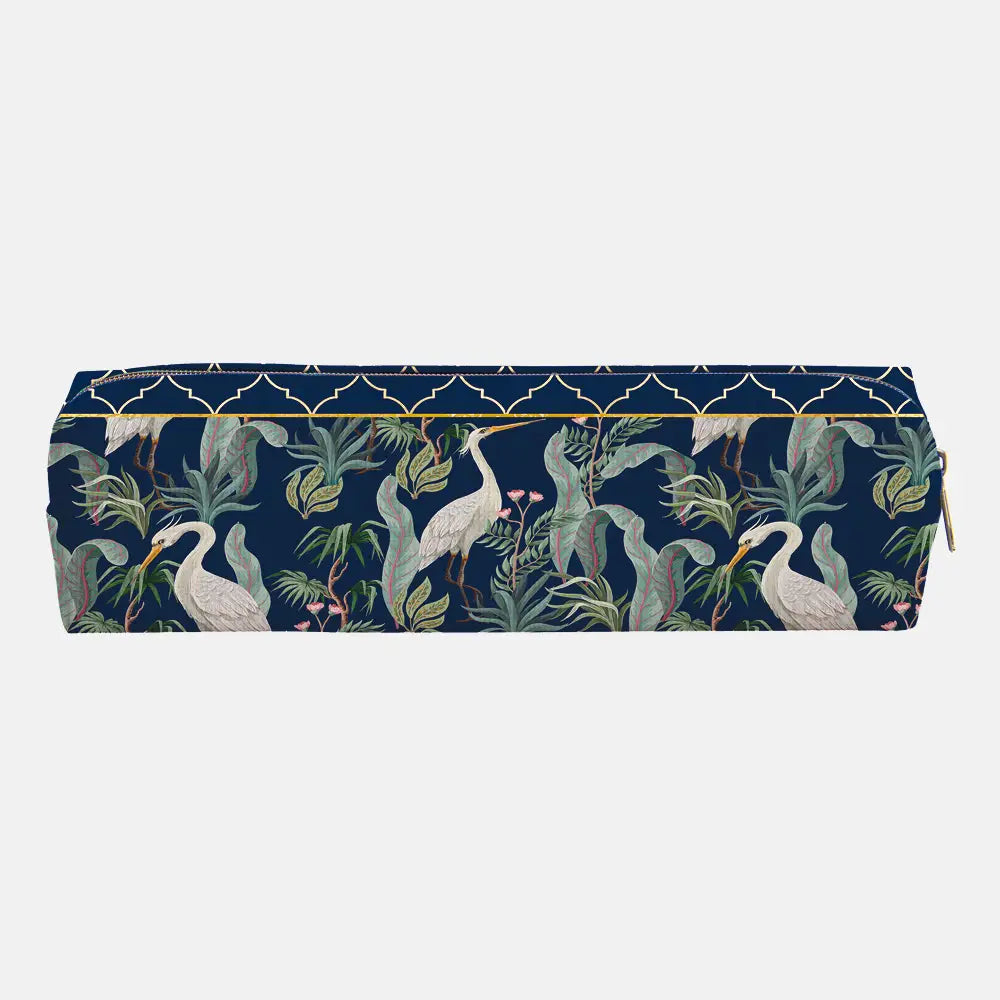 A rectangular zippered pouch featuring a navy blue background with a detailed pattern of white herons, green tropical leaves, and a gold trellis design along the top edge.