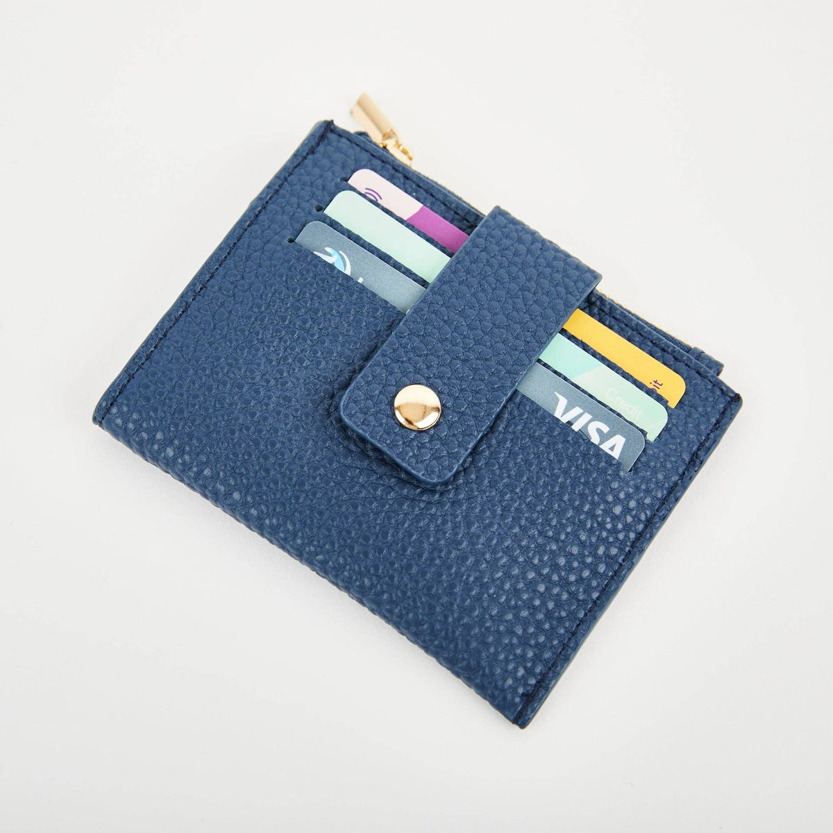 Navy Pearl Duo purse holding cards beneath its press-stud security tab.