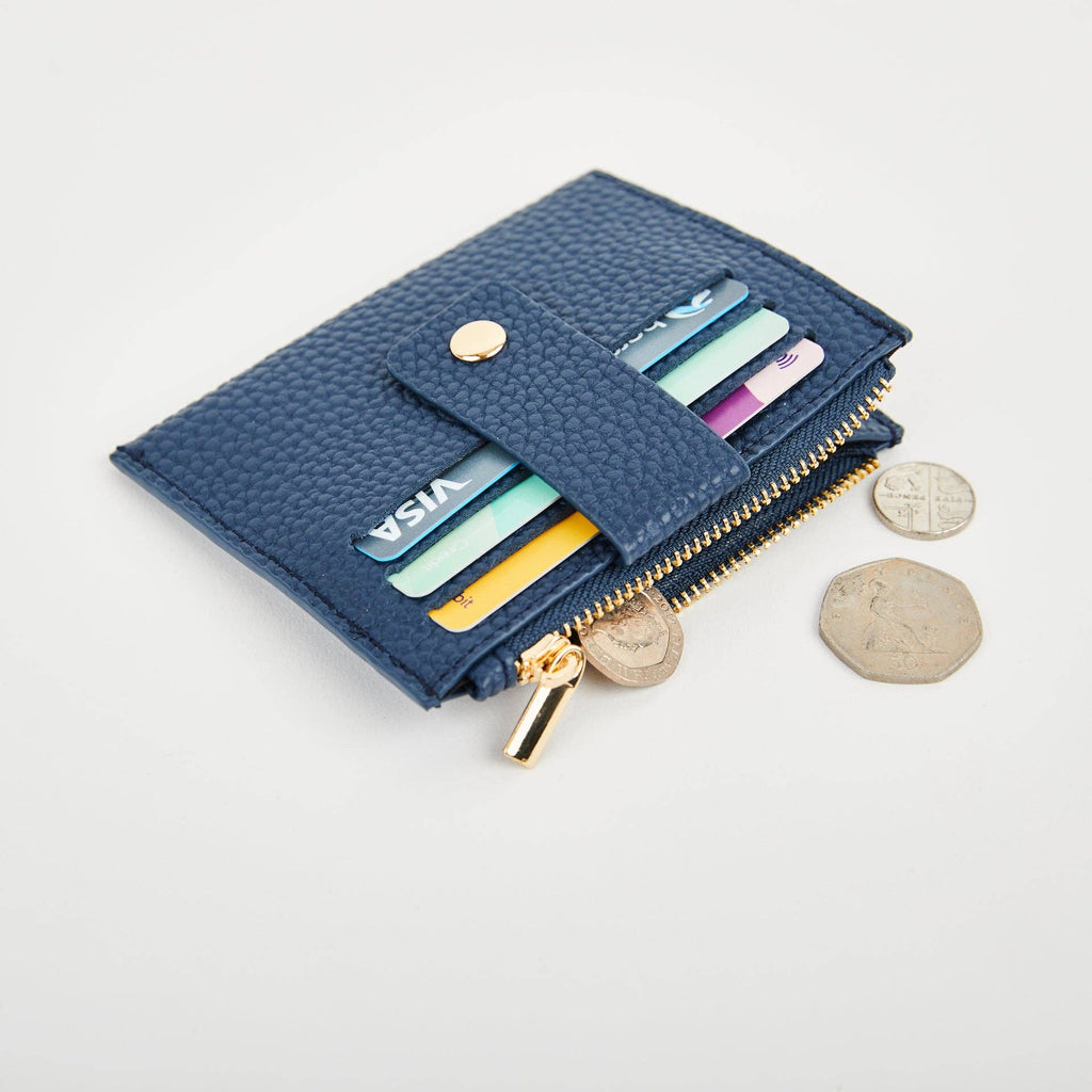 Navy Pearl Duo purse with cards in the front slots and an open zip compartment beside loose coins