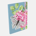 Notebook with a butterfly and floral design on a blue background