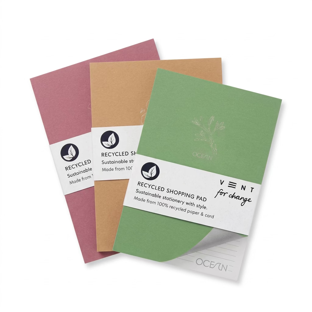 Set of three recycled shopping pads in Coral Pink, Sandy Yellow and Algae Green on a white background