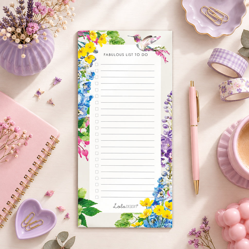 Botanical Hummingbird magnetic to do list notepad on a pale desk top with pink and lilac accessories and a lilac teacup