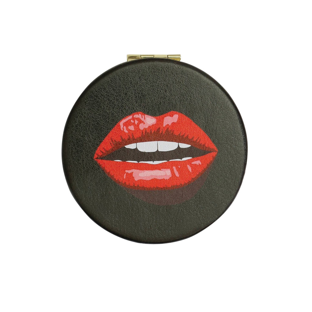 A round black leather compact case featuring a graphic illustration of red lips with white teeth, shown against a plain white background.