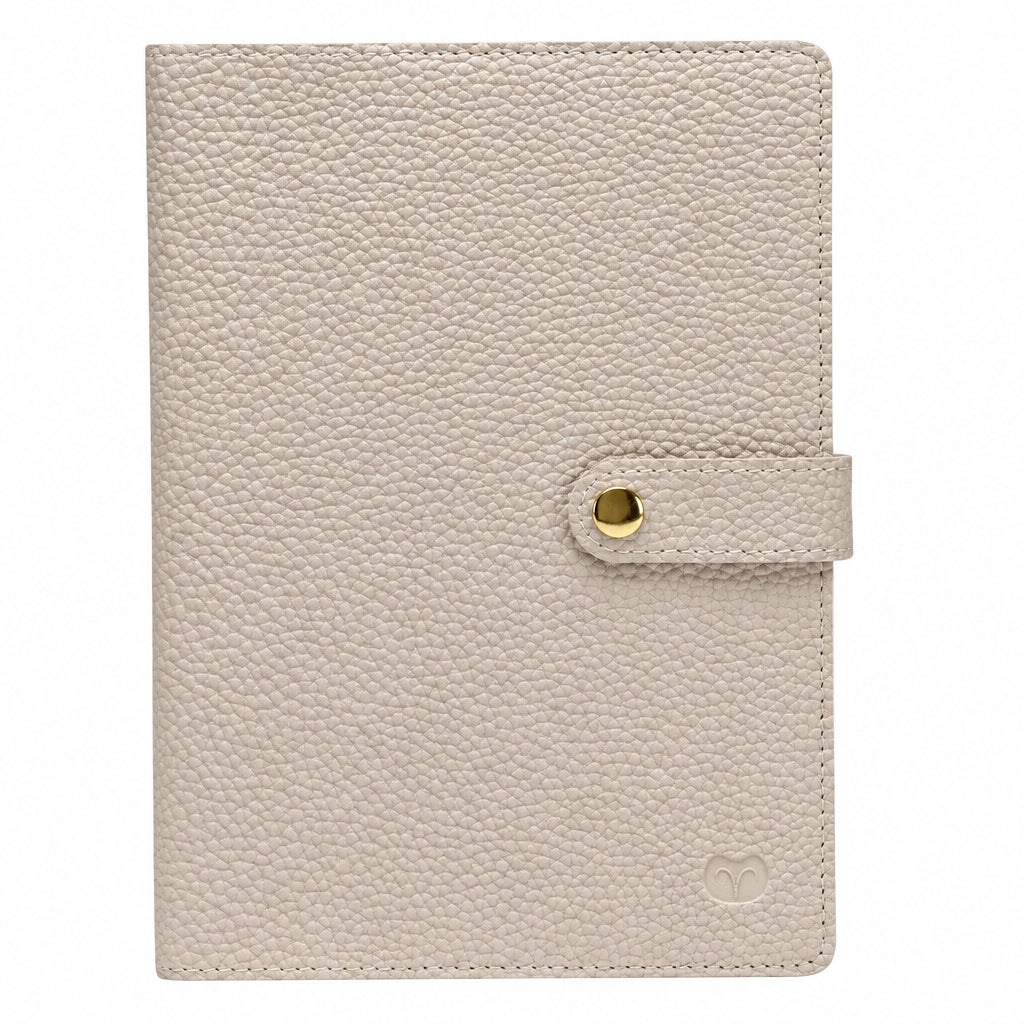 Nude A5 notebook with a textured cover and matching snap-button strap closure, on a white background.