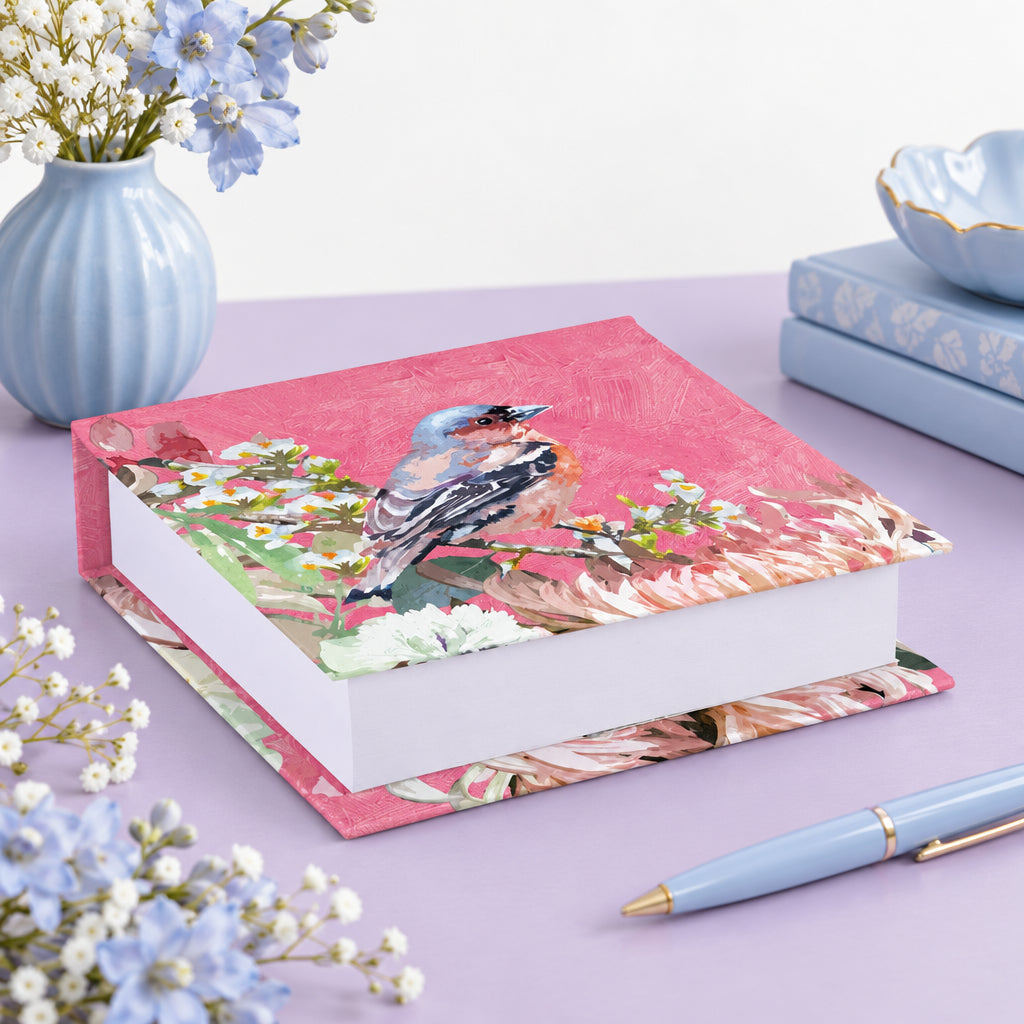 Decorative box with a bird and floral design on a pink background