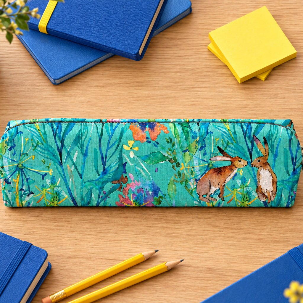 A rectangular zippered pencil case featuring a colorful watercolor-style print of two hares among blue-green foliage and wildflowers, shown on a plain light gray background.