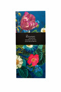 A tall rectangular botanical magnetic list pad from The Botanist Collection, featuring a dark blue background with vibrant pink, red, and white flowers and green leaves, wrapped in a black paper band with white text.