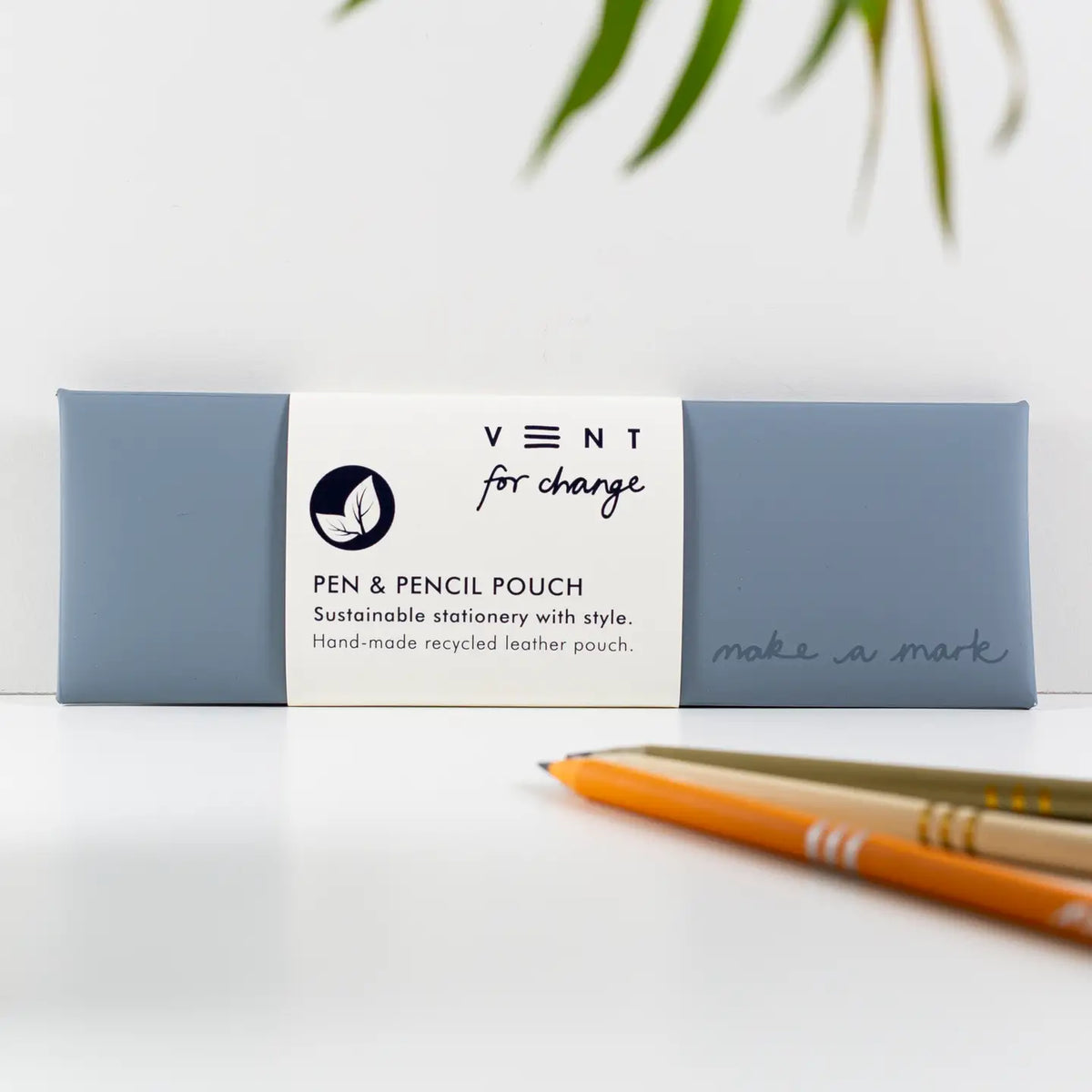 Dusty Blue recycled leather pen and pencil case with a white paper sleeve, displayed beside pencils